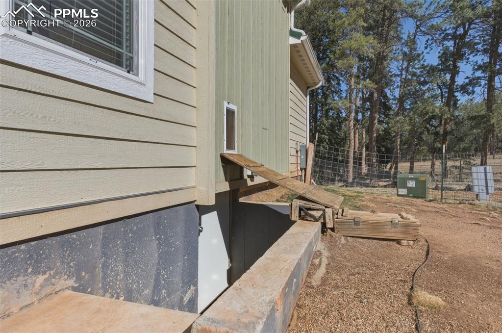 Image 4 of 23: Steps leading to the spacious crawl space adding additional storage