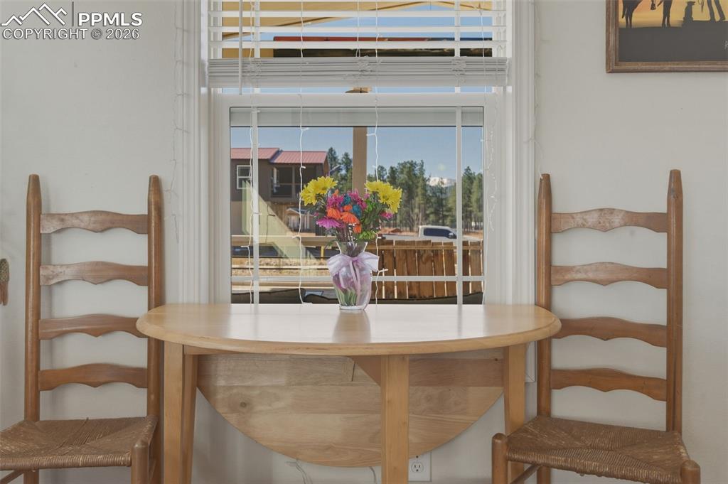 Image 9 of 23: Lovely dining area offers a window with views