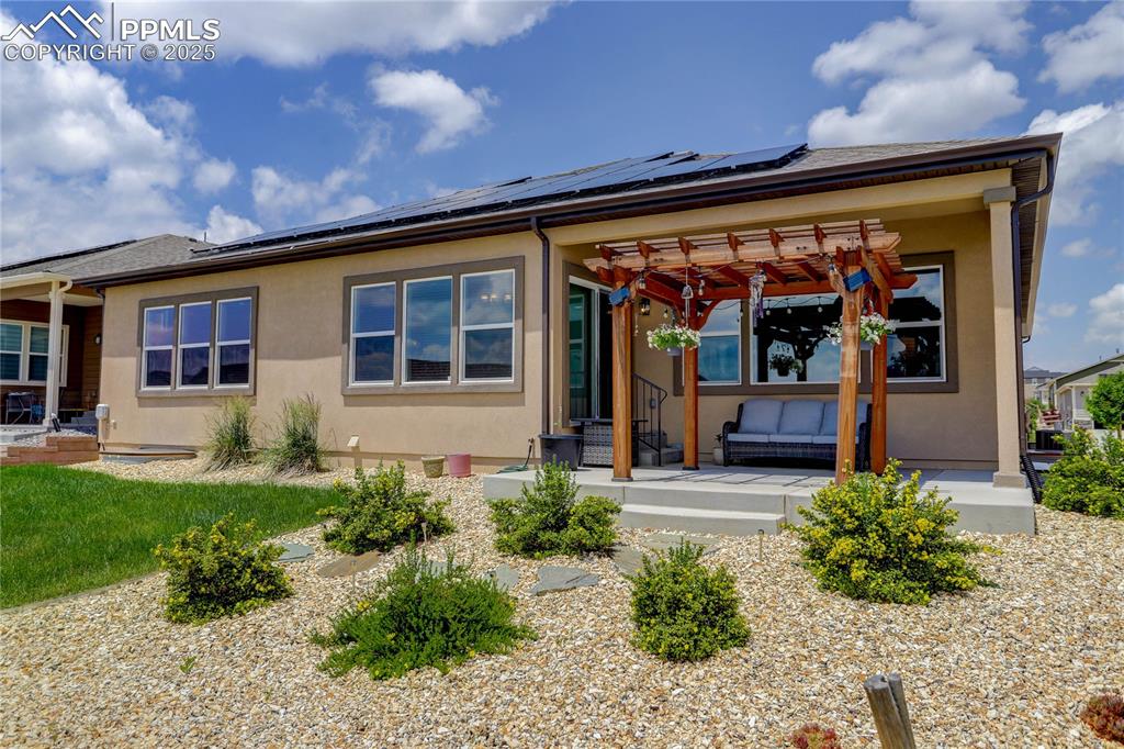 Image 32 of 38: Extended patio w/ pergola