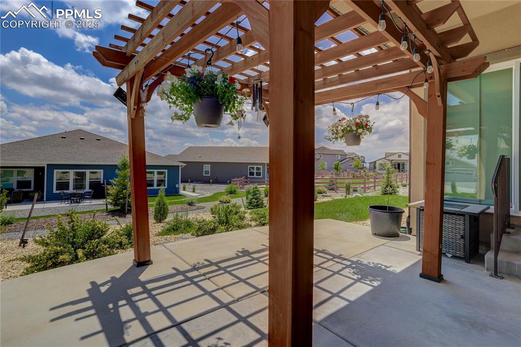Image 35 of 38: View of patio / terrace with a pergola and a residential view