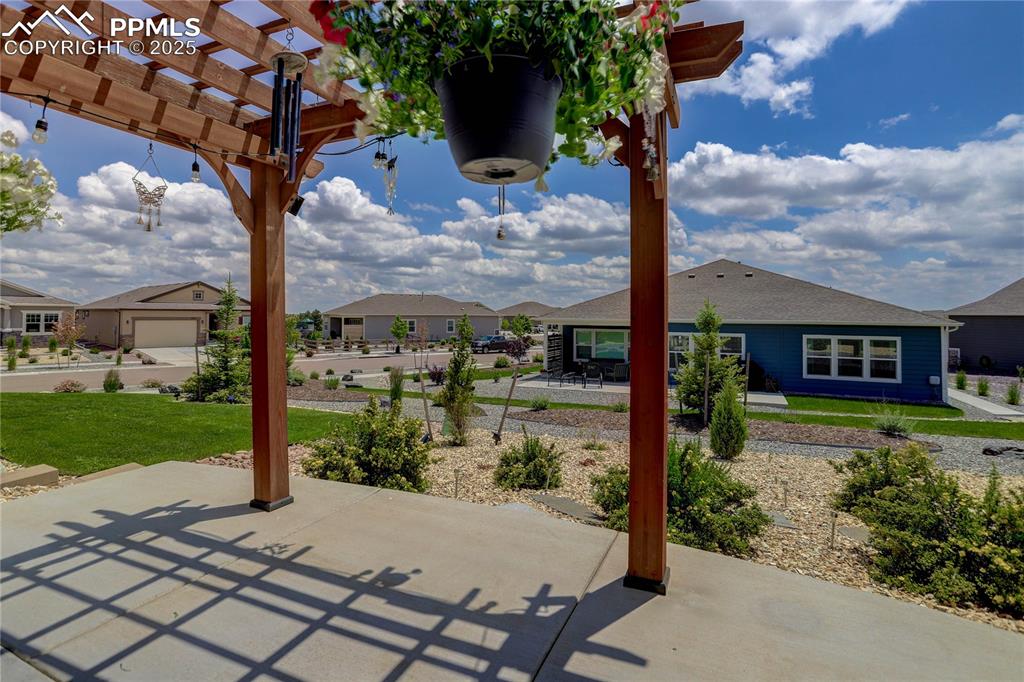 Image 36 of 38: View of patio with a pergola and a residential view