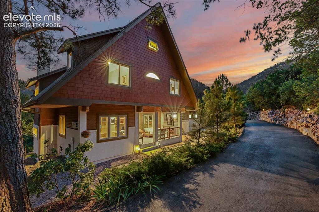 Image 1 of 50: Twilight welcomes you home as this custom mountain retreat blends beautiful