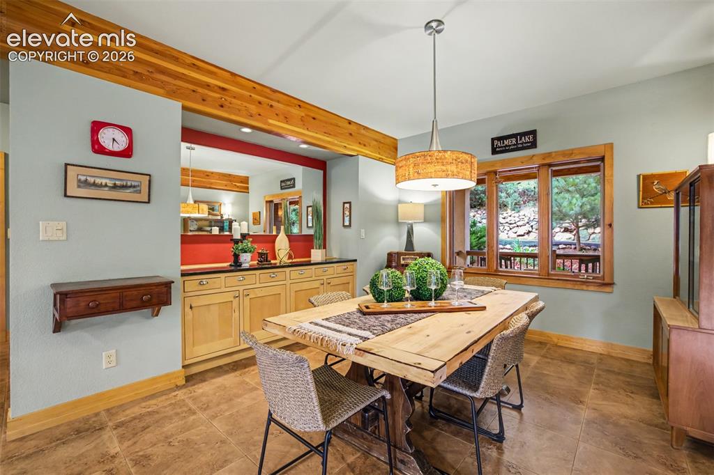 Image 11 of 50: The dining room features custom built-ins, a slab granite serving buffet an