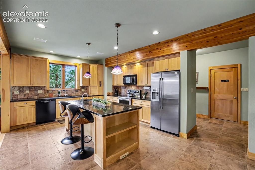 Image 14 of 50: The oversized island provides additional workspace and casual seating.