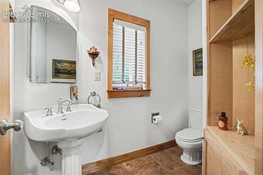 Image 18 of 50: The main-level powder room is conveniently located for guests.