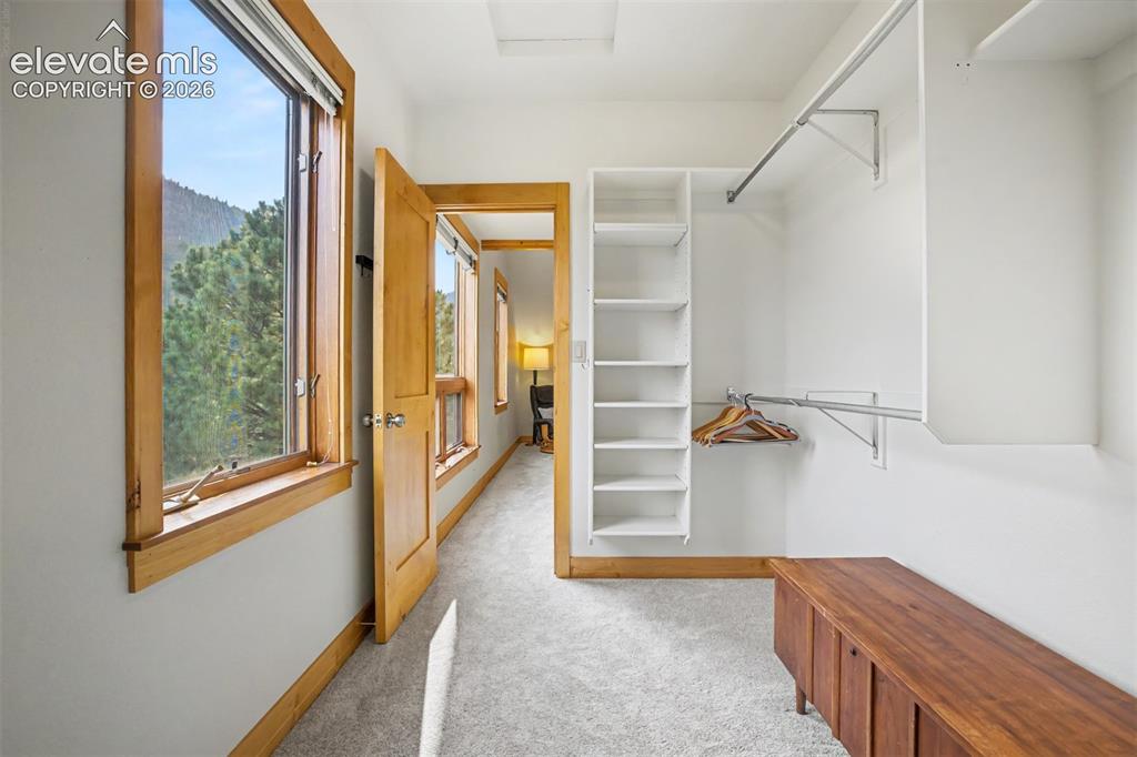 Image 21 of 50: The oversized walk-in closet offers exceptional storage with custom shelvin