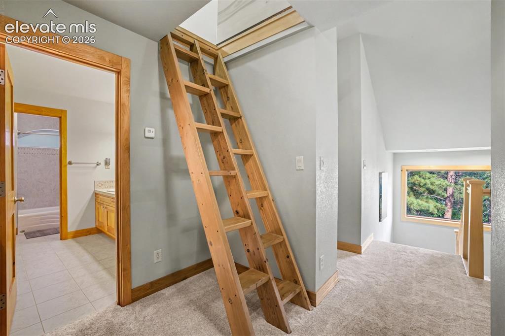 Image 29 of 50: A loft ladder provides access to additional finished loft space.