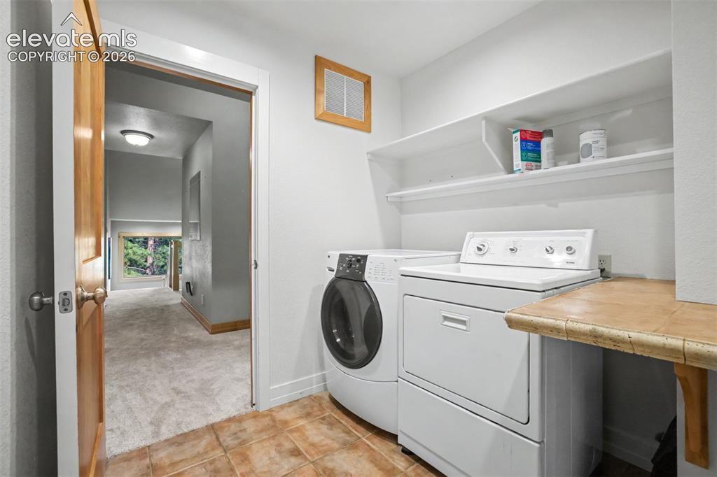 Image 31 of 50: The laundry room includes access to the whole house fan, a utility sink, ge