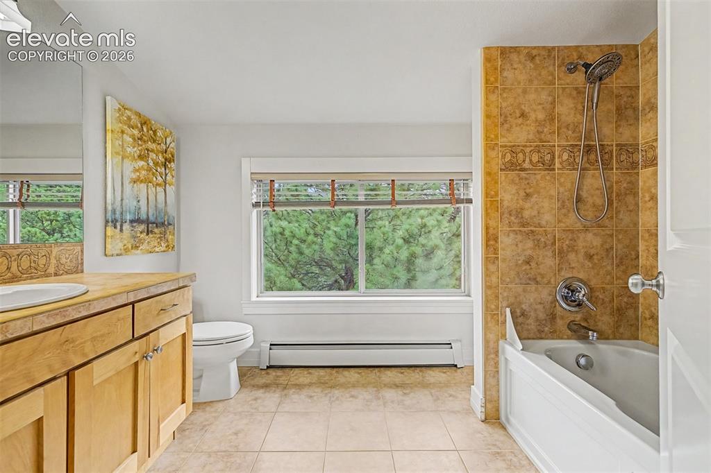 Image 33 of 50: The private guest bathroom serves the upper-level guest suite with a spacio