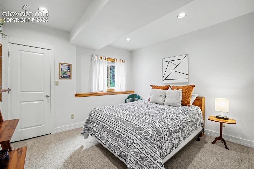 Image 38 of 50: The basement guest bedroom features a spacious closet and convenient access