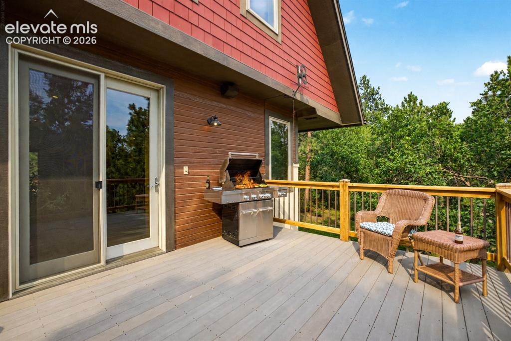 Image 5 of 50: The composite deck extends the living space with peaceful forest views and 