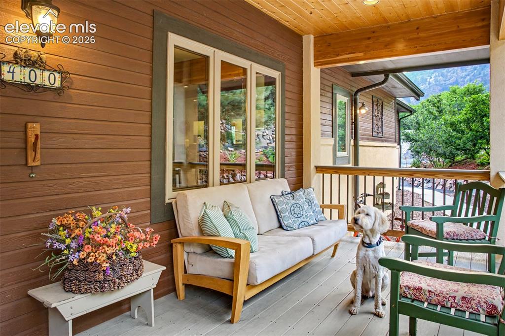 Image 7 of 50: The covered front porch provides a welcoming place to relax and enjoy the m