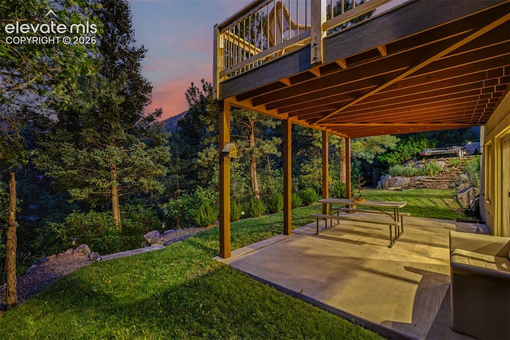Image 9 of 50: The walk-out lower patio offers covered outdoor living overlooking the land