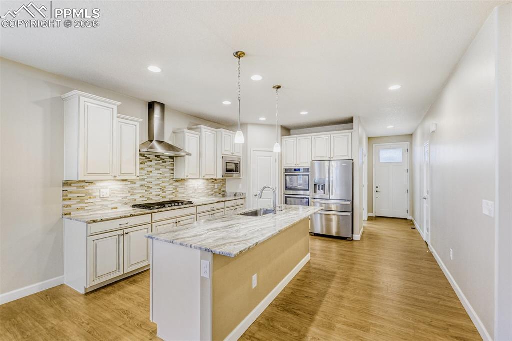 Image 9 of 49: gas range, double ovens, 42" cabinetry, undercabinet lighting