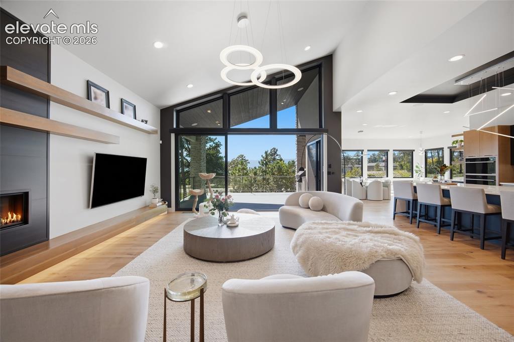 Image 13 of 50: Vaulted ceilings with recessed lighting, large format windows, built-in fir