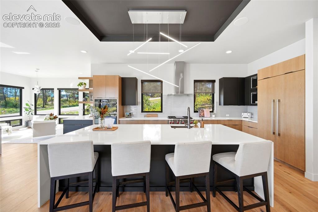 Image 17 of 50: Expansive kitchen island with a white countertop