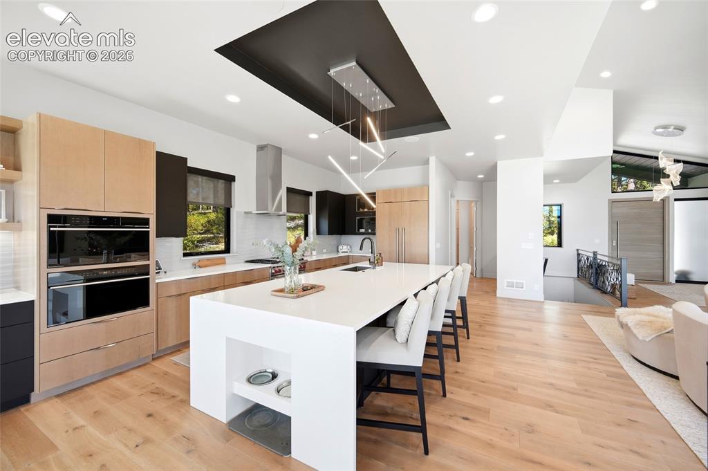 Image 18 of 50: Gourmet kitchen with light wood-finish cabinetry, stainless steel appliance