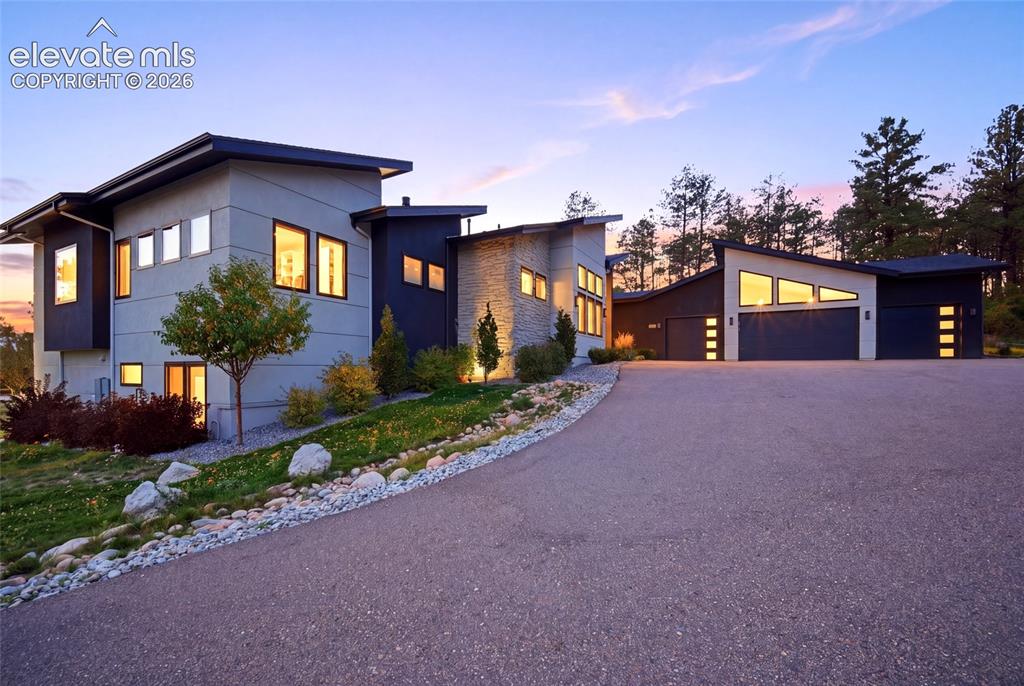 Image 2 of 50: Multi-level contemporary exterior with stone accents, clean lines, large wi