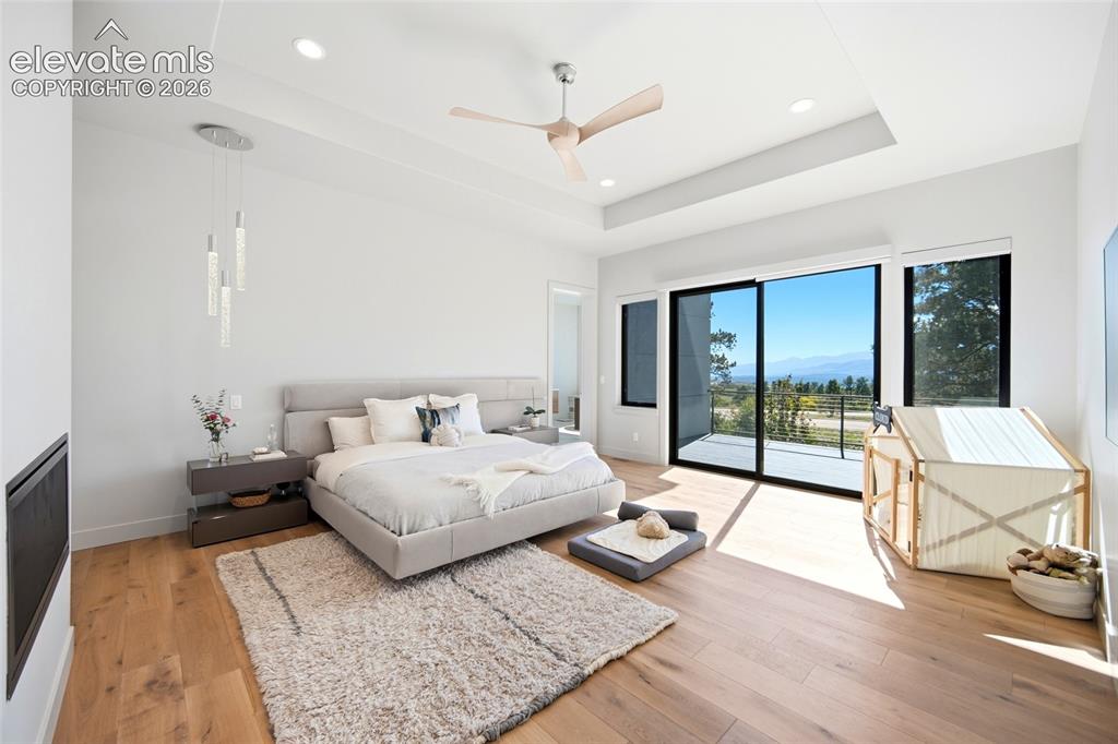 Image 27 of 50: Hardwood flooring throughout, recessed lighting, and a modern ceiling fan