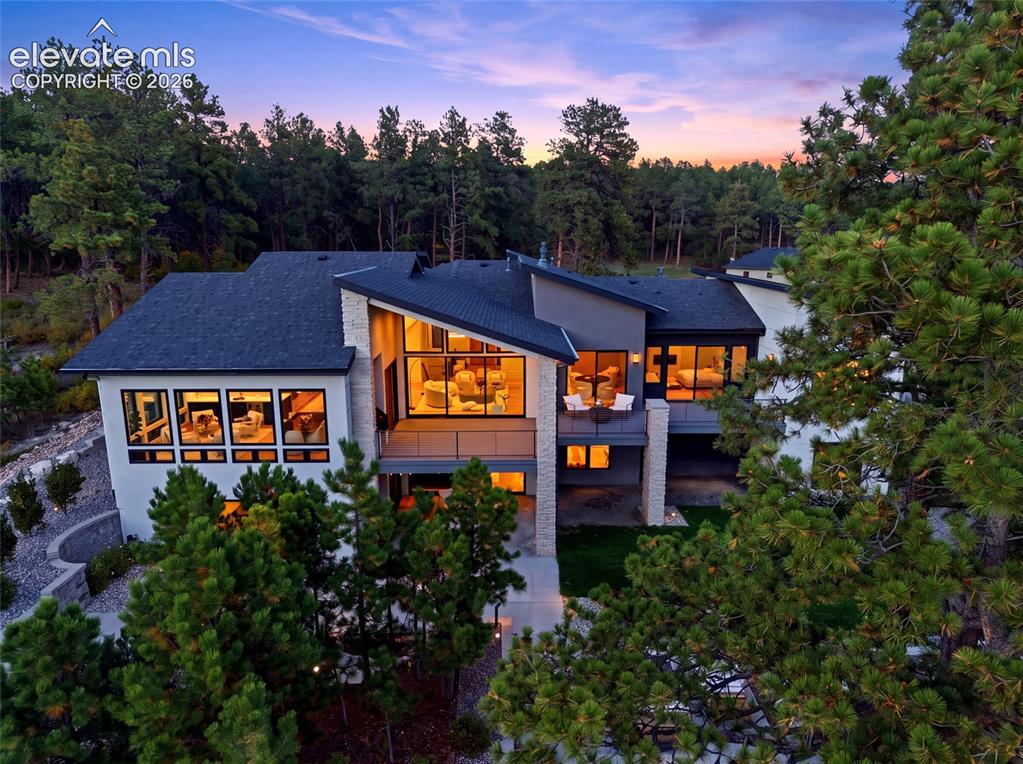Image 3 of 50: Contemporary architecture with multiple rooflines and extensive fenestratio