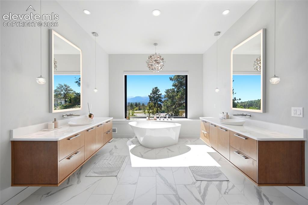 Image 30 of 50: Freestanding soaking tub, dual floating wood-finish vanities with vessel si