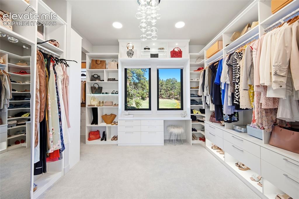 Image 33 of 50: Custom built-in white cabinetry, integrated shelving and drawers, recessed