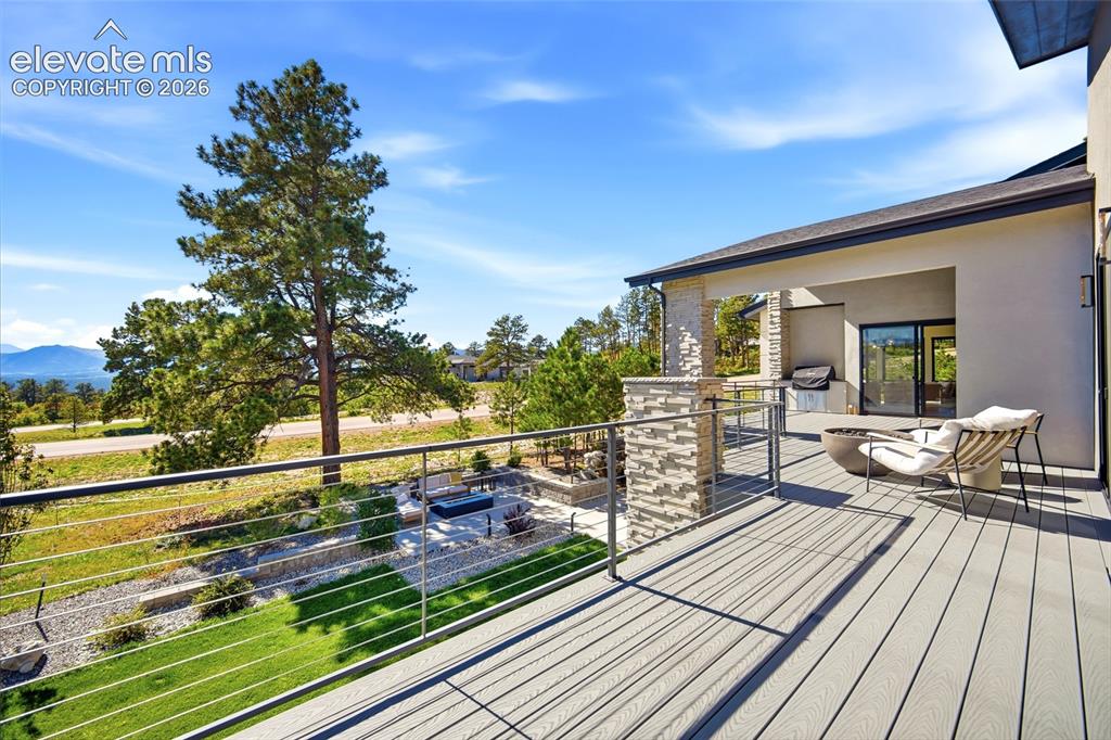 Image 35 of 50: Expansive outdoor deck featuring composite decking, cable railing, and a st