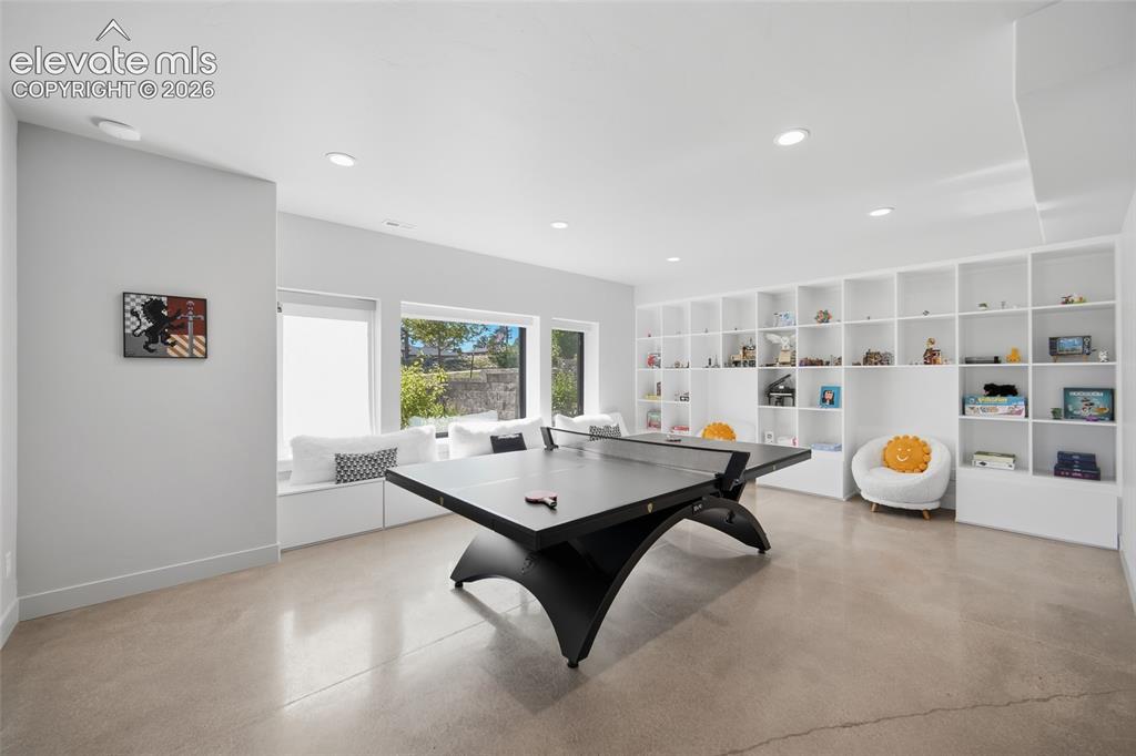 Image 42 of 50: Polished concrete flooring, recessed lighting, built-in shelving, large win