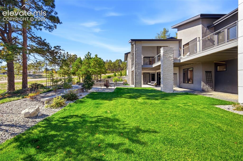 Image 48 of 50: Modern architecture with stucco and stone accents, multiple outdoor balconi