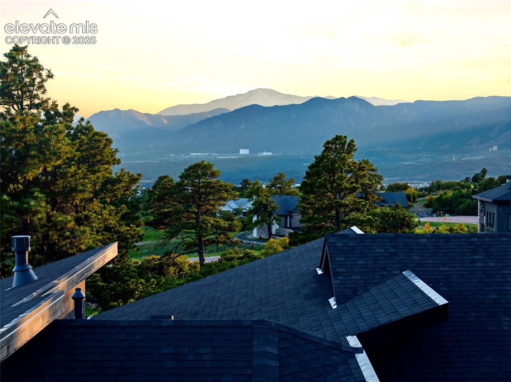 Image 50 of 50: Expansive mountain backdrop with a town in the distance