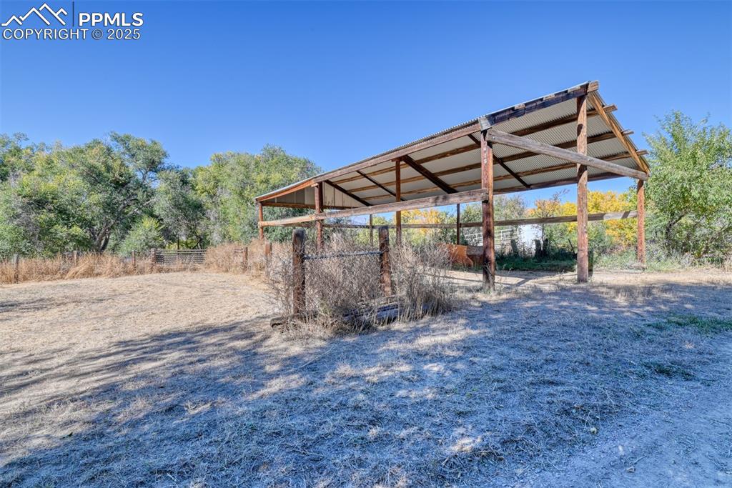 Image 15 of 50: Pole barn with new metal roof, conveniently next to a corral