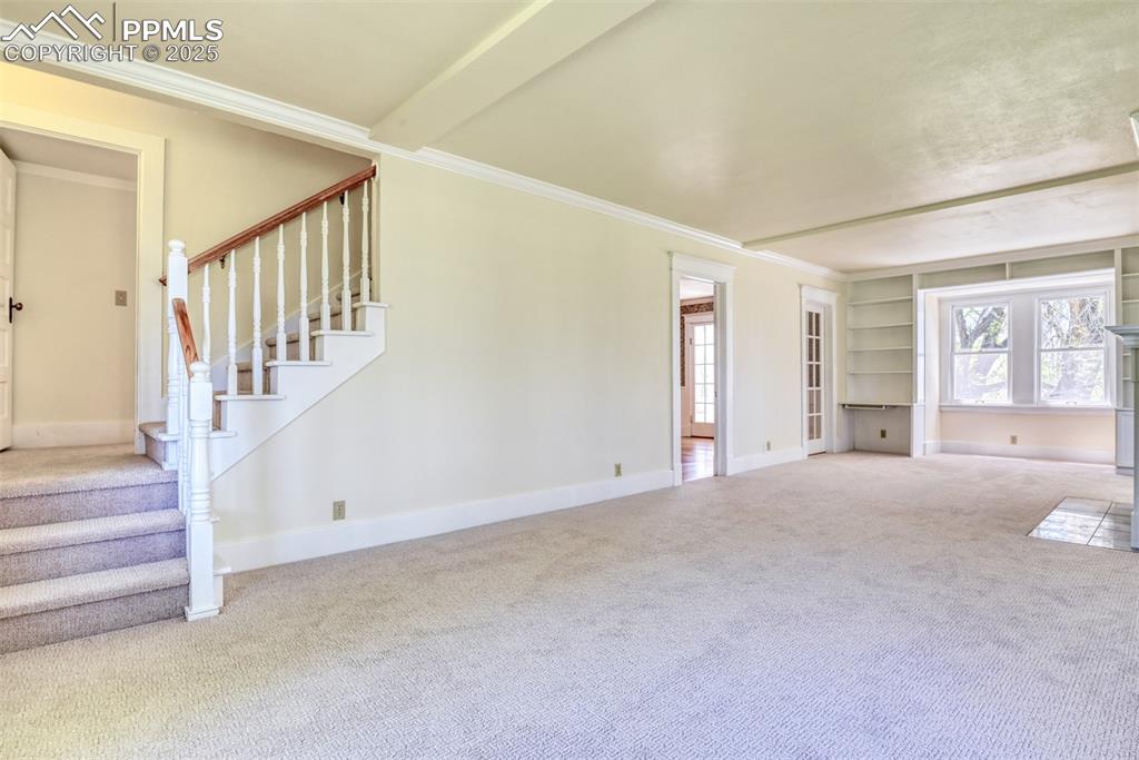 Image 28 of 50: Expansive living room with built-ins