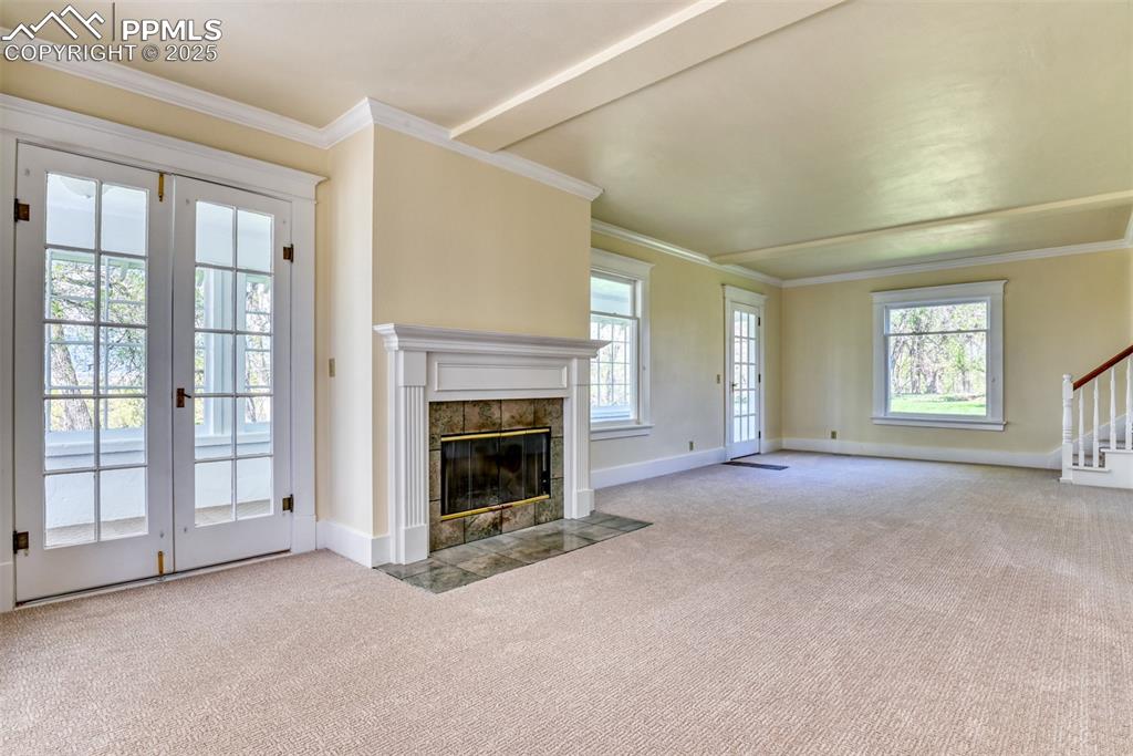 Image 29 of 50: Wood burning fireplace and entrance to garden room