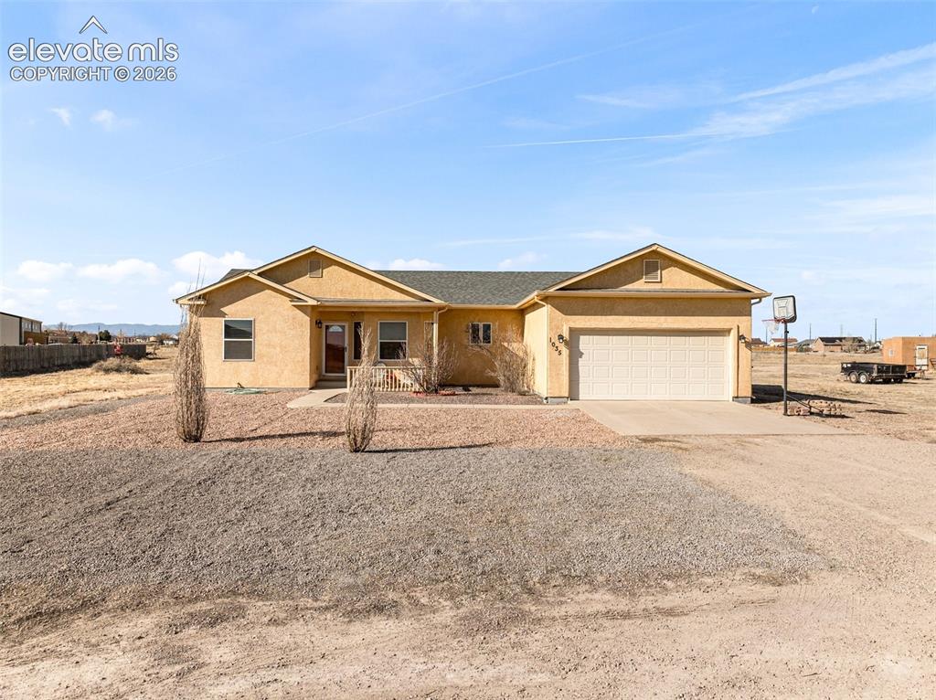 Image 1 of 49: Stucco exterior with a two-car garage