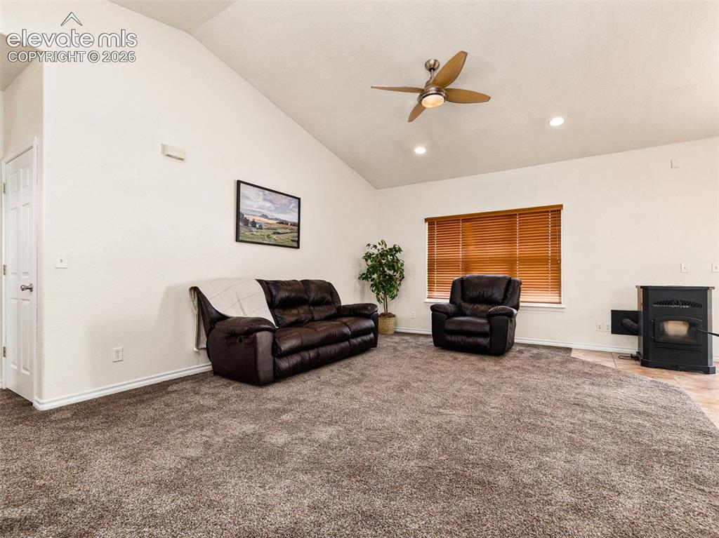 Image 4 of 49: Vaulted ceiling with a ceiling fan, recessed lighting, and a window with wo