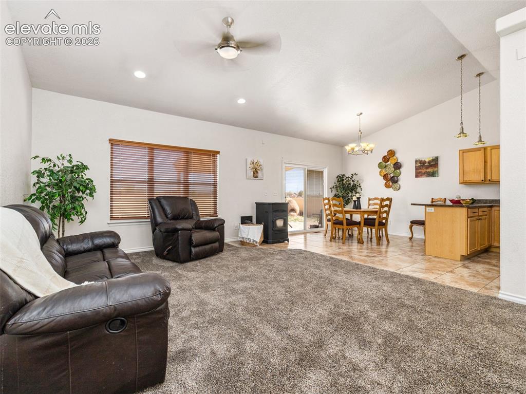 Image 41 of 49: Open-concept living space featuring vaulted ceilings, recessed lighting, a 