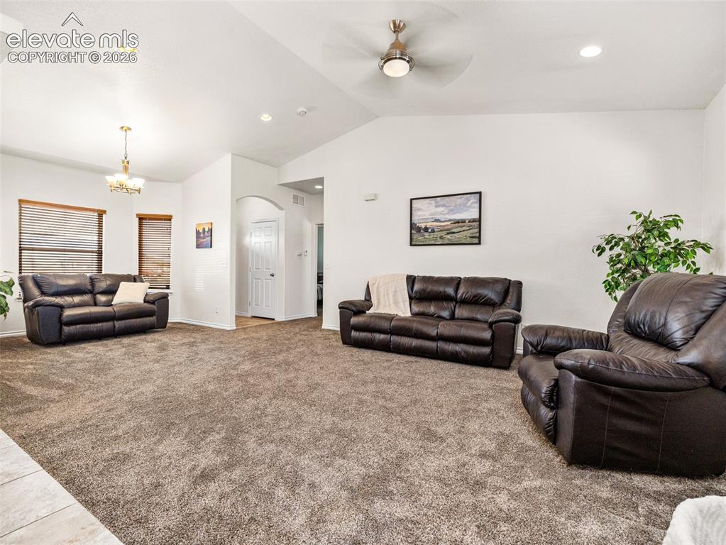 Image 42 of 49: Vaulted ceiling with a ceiling fan, recessed lighting, and wall-to-wall car