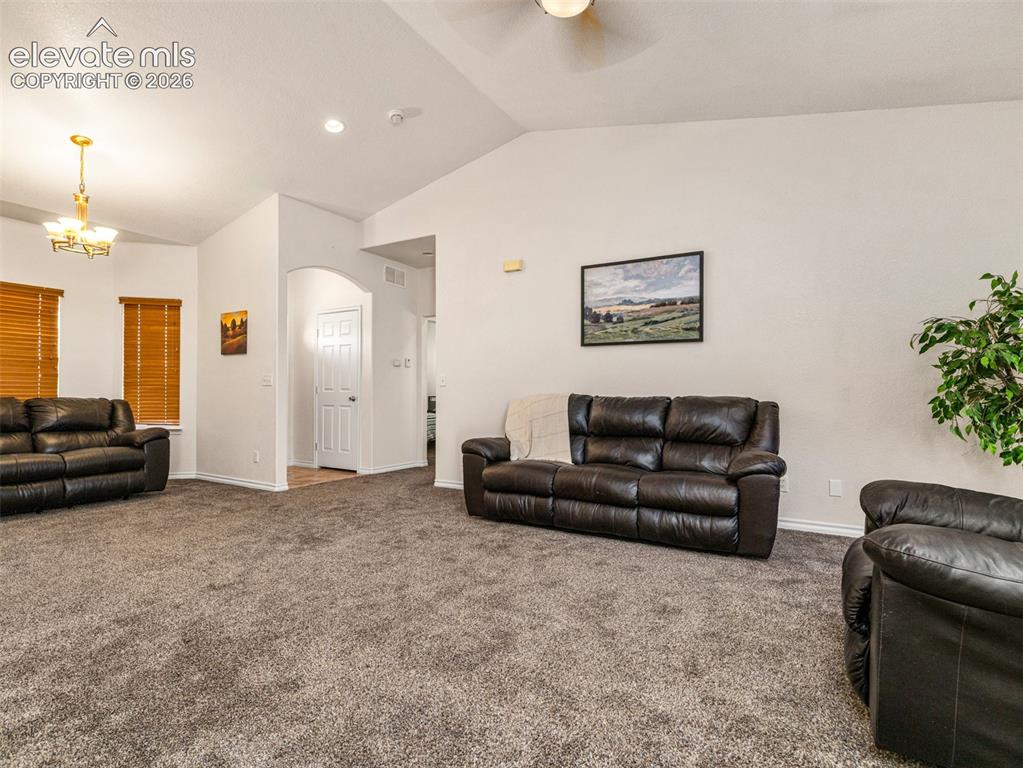 Image 5 of 49: Vaulted ceilings with a ceiling fan, recessed lighting, and a chandelier il