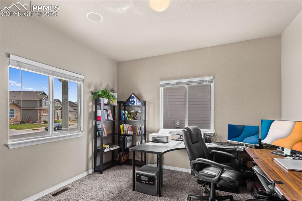 Image 16 of 21: Large office separated from the rest of the house.