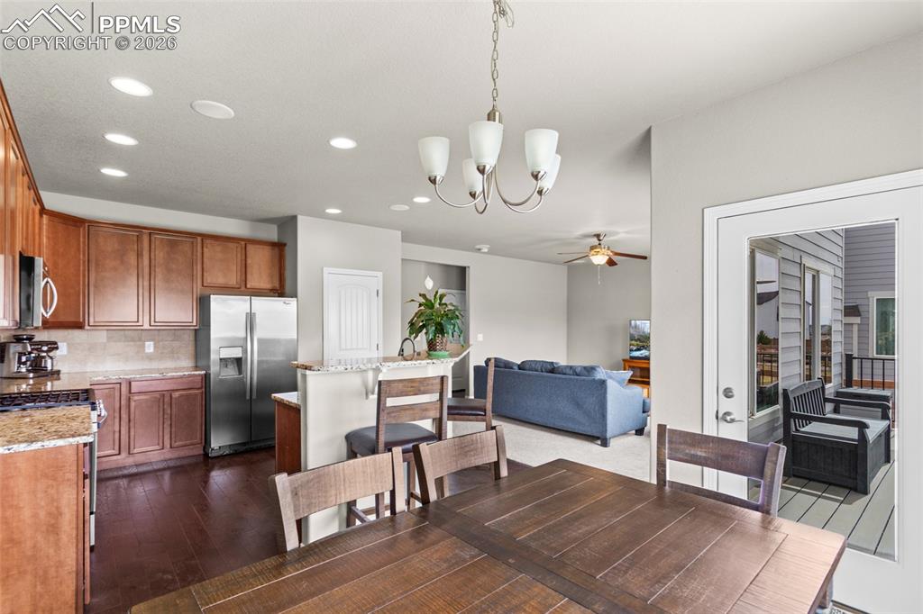 Image 4 of 21: Open-concept kitchen and dining area featuring wood-finish flooring, recess