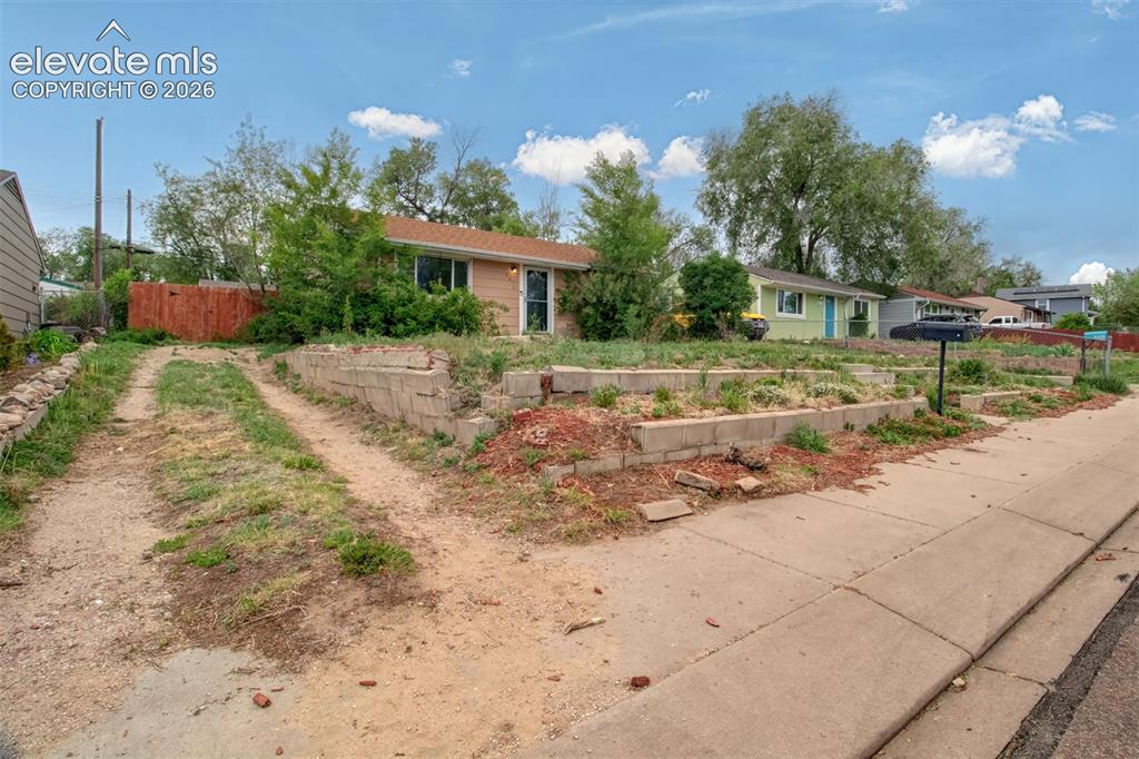 Image 18 of 19: Front of home with driveway