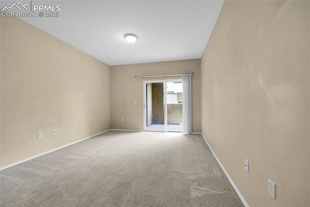 Image 12 of 18: Carpeted empty room featuring baseboards