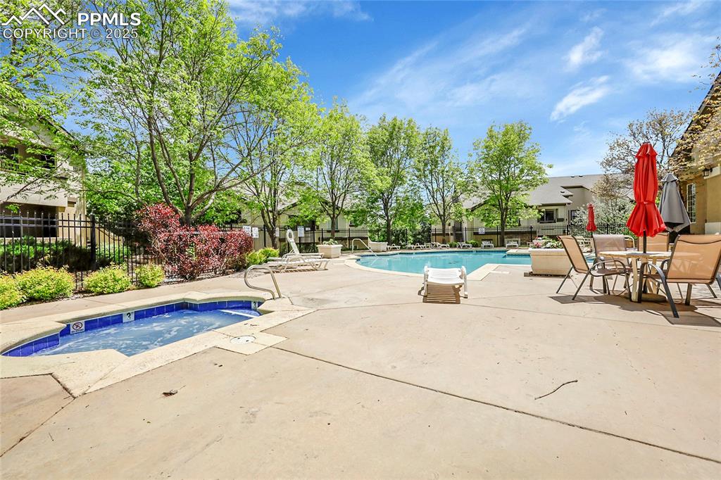 Image 16 of 18: Community pool featuring a patio and a hot tub