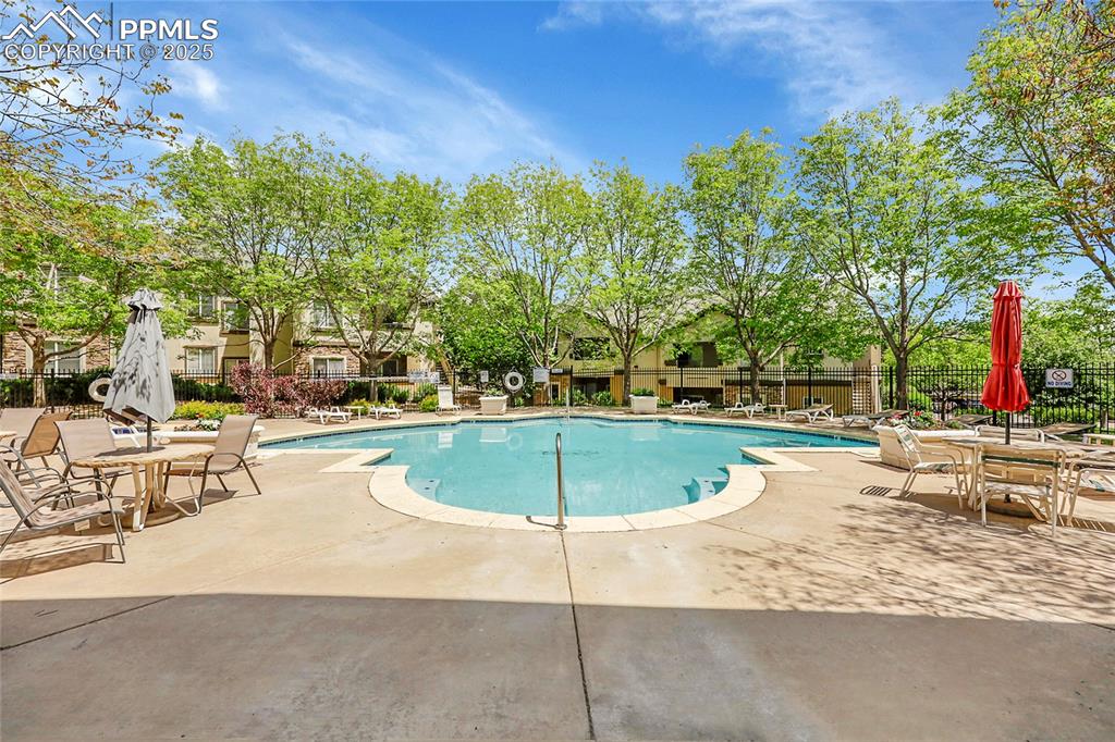 Image 17 of 18: Community pool featuring a patio area