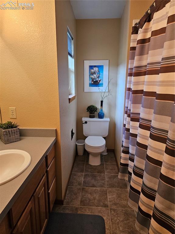 Image 18 of 44: Guest Bathroom with vanity, a textured wall, and a tub/shower