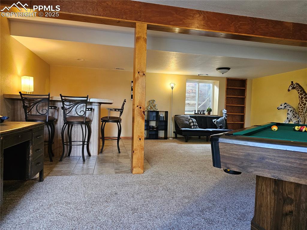 Image 20 of 44: Basement Recreation room with light carpet, billiards, light tile patterned