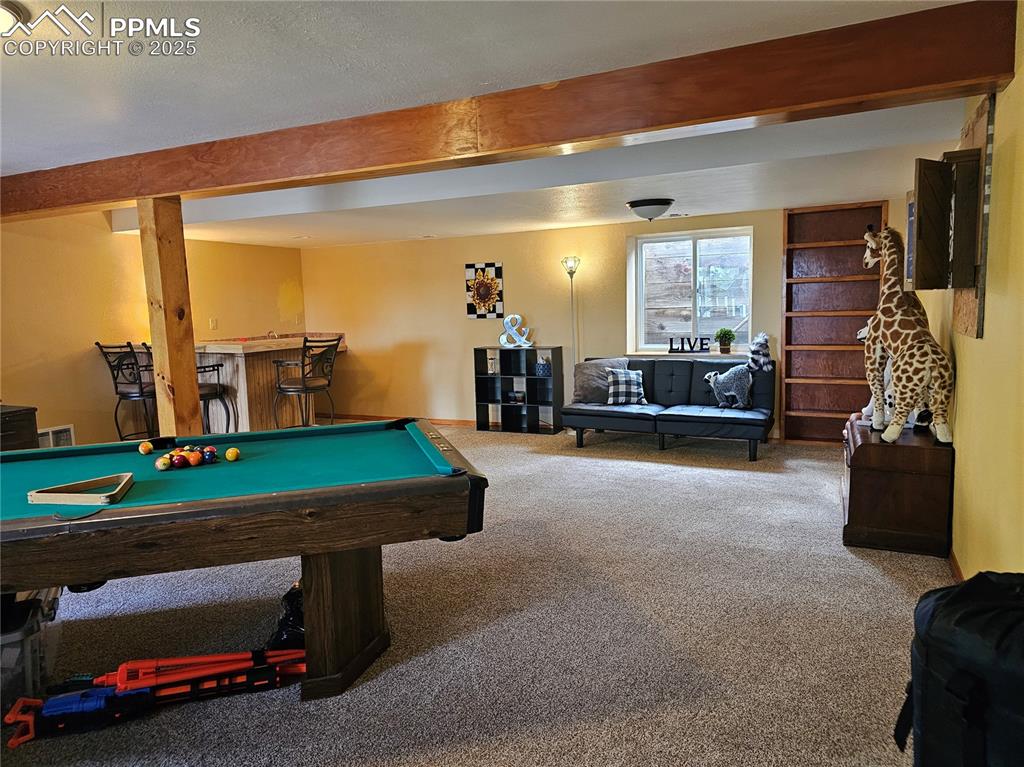 Image 21 of 44: Basement Rec room, billiards, and bar,