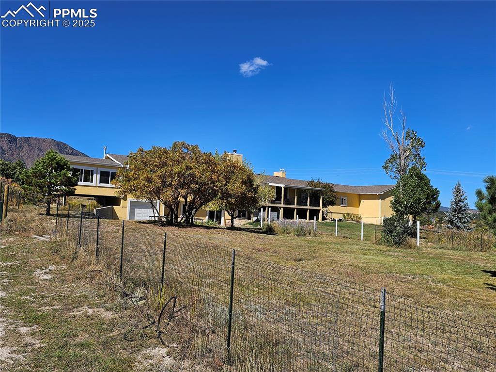 Image 3 of 44: Rear of home and dog run.