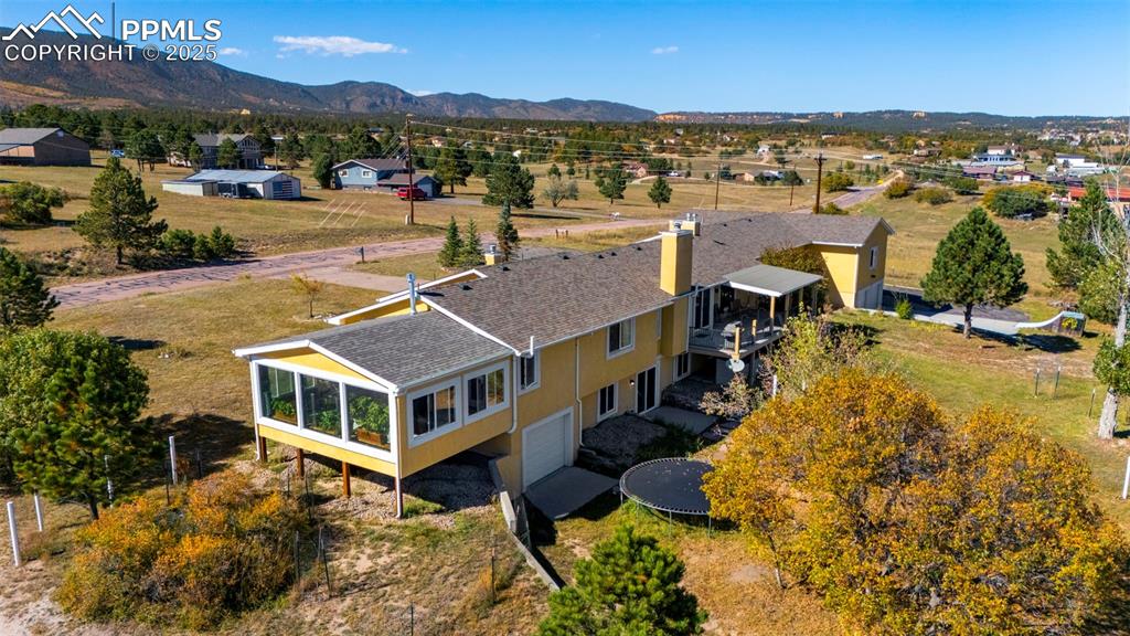 Image 37 of 44: View from above of property featuring a mountainous background