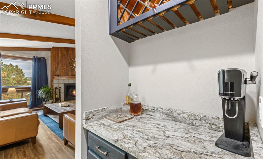 Image 11 of 21: Kitchen featuring light stone countertops, dark wood finished floors, a fir
